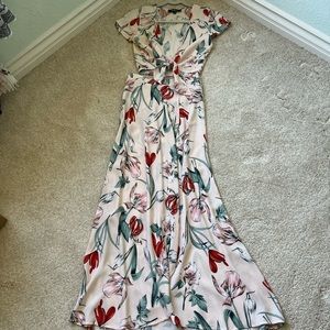 Lulu’s light pink 2 piece skirt and crop top set. Green leaves and red flowers